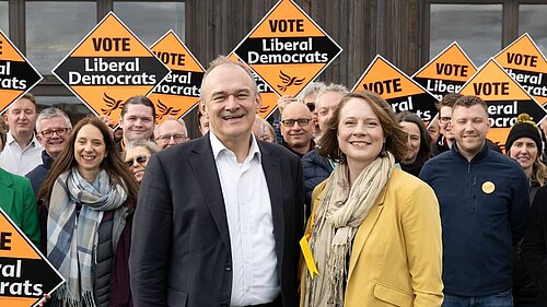 Cheney and Ed Davey in front of a crowd of Lib Dems