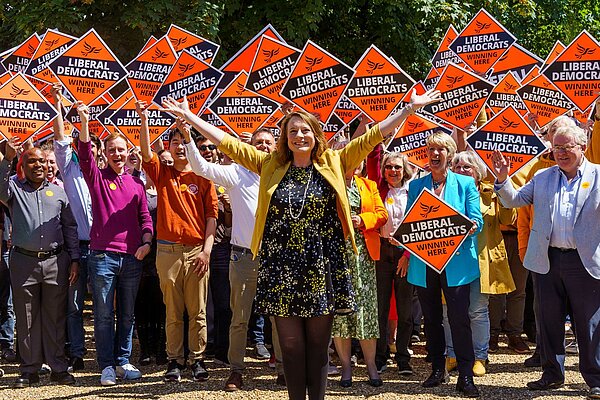 Cheney Payne in front of a group of happy Lib Dems