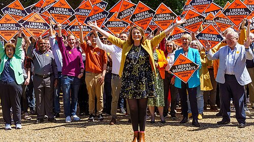 Cheney in front of a crowd of people