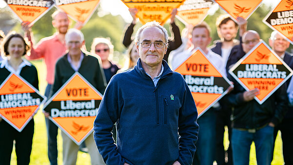 John in front of a group of Lib Dems