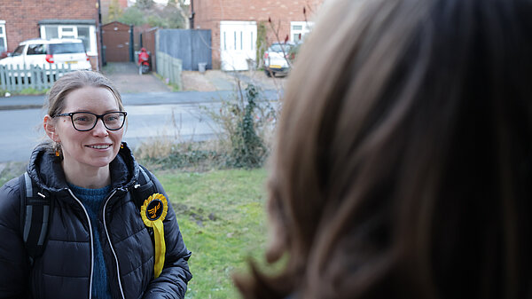 Ania talking to someone on a doorstep