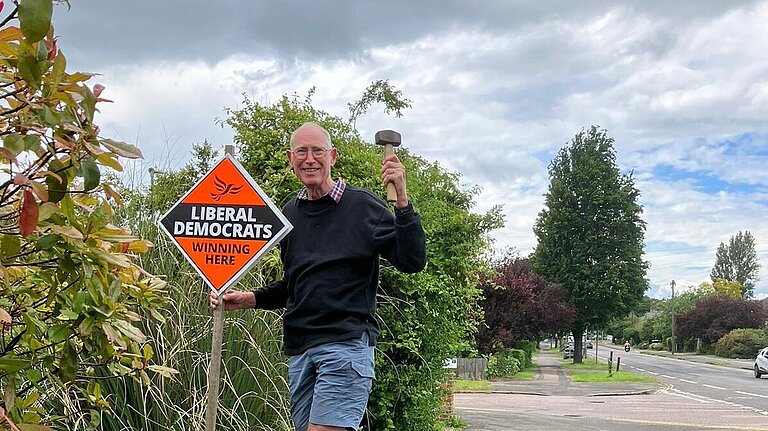 David Levien putting up a Lib Dem poster